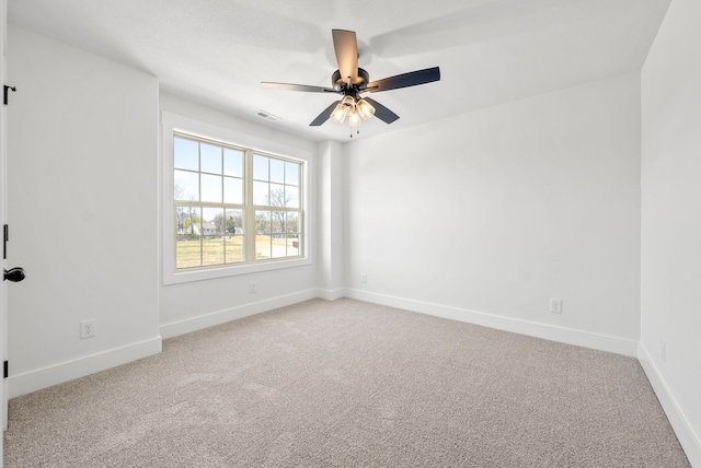 carpeted spare room with ceiling fan