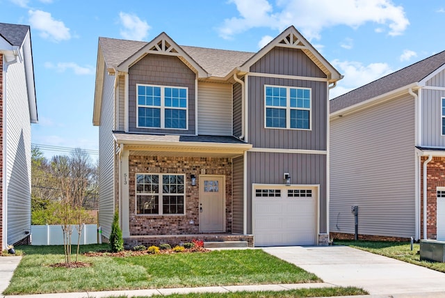 view of front of property featuring a front yard and a garage