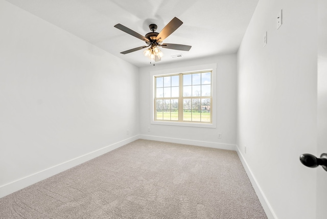 empty room featuring ceiling fan and carpet