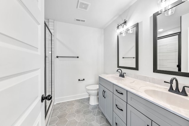 bathroom featuring tile patterned floors, vanity, toilet, and walk in shower