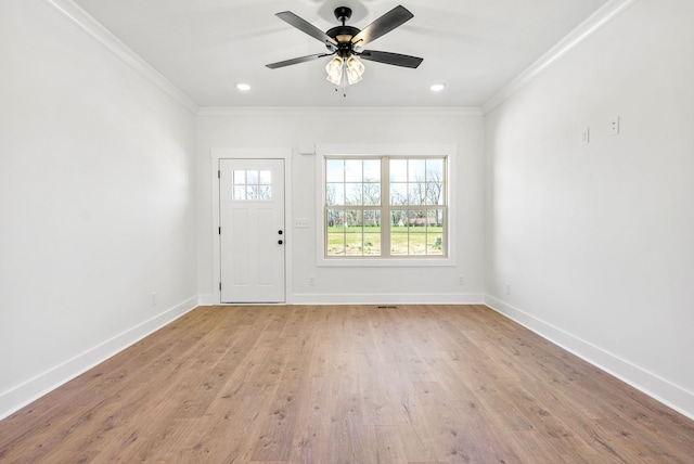 entryway with light wood-type flooring, ceiling fan, and ornamental molding