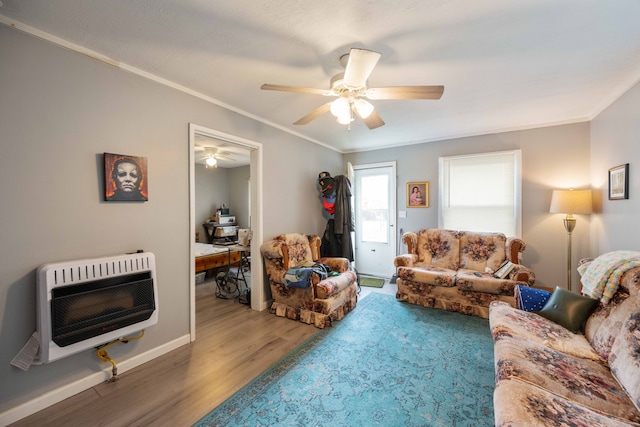 living room with hardwood / wood-style flooring, ceiling fan, ornamental molding, and heating unit