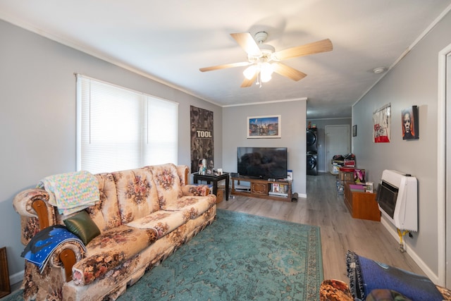 living room featuring heating unit, ceiling fan, light hardwood / wood-style flooring, and crown molding