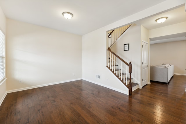 spare room featuring dark hardwood / wood-style flooring