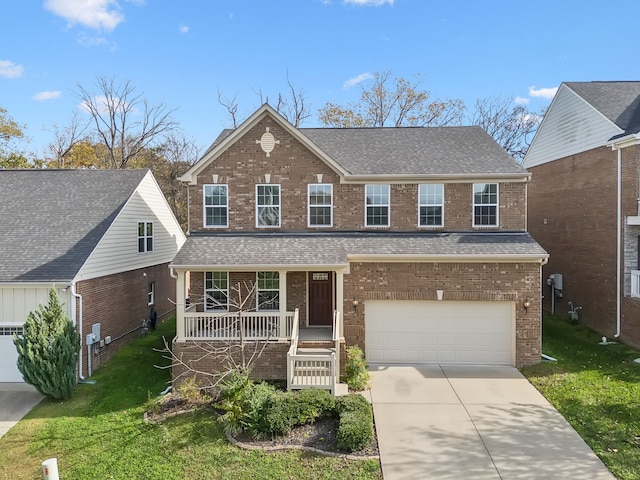 view of property featuring a porch, a garage, and a front yard