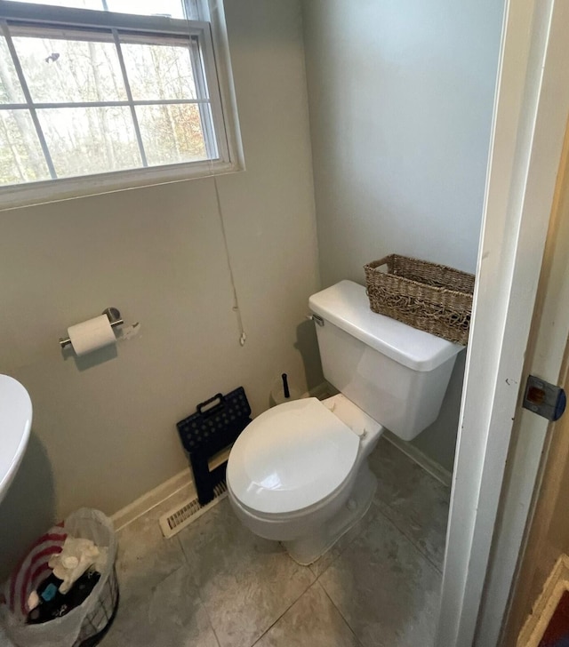 bathroom with tile patterned flooring and toilet