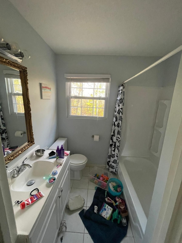 bathroom with toilet, vanity, tile patterned floors, and plenty of natural light