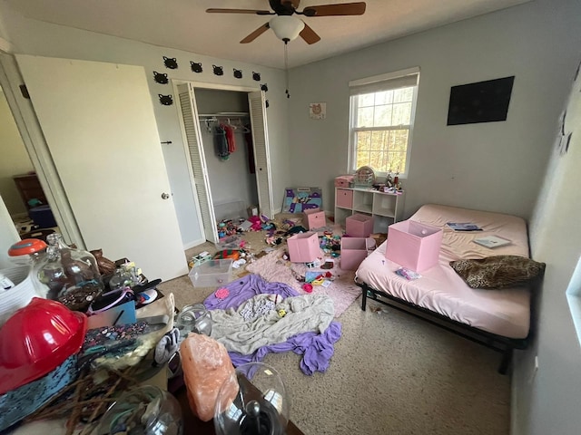 carpeted bedroom featuring a closet and ceiling fan