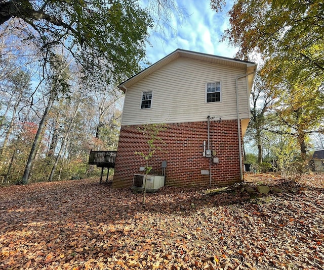 view of side of home featuring central AC and a wooden deck