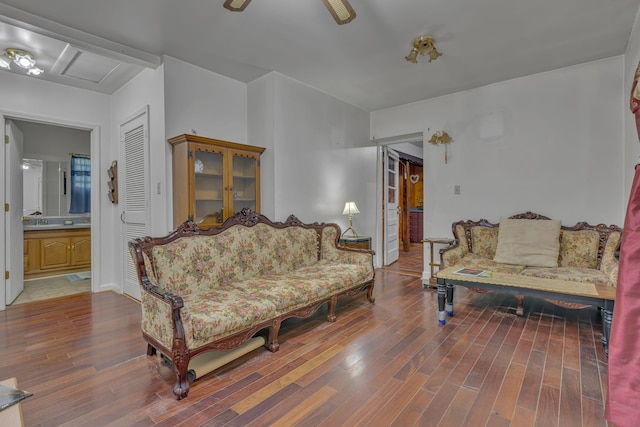 living room featuring wood-type flooring and ceiling fan