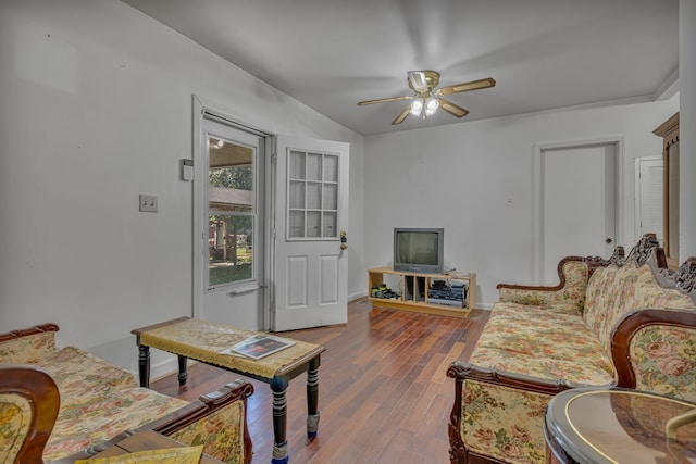 living room with ceiling fan, dark hardwood / wood-style flooring, and vaulted ceiling