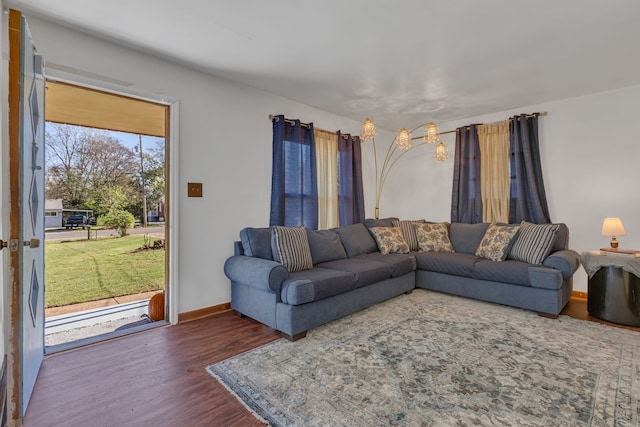 living room featuring plenty of natural light and dark hardwood / wood-style flooring