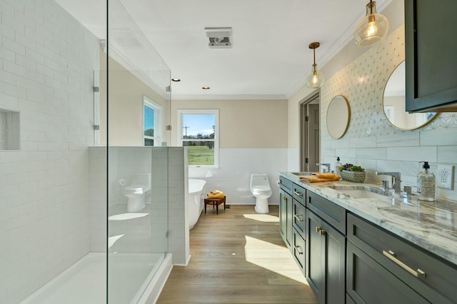 full bathroom featuring ornamental molding, hardwood / wood-style flooring, tile walls, shower with separate bathtub, and toilet