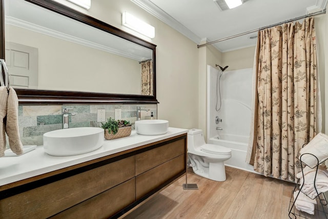 full bathroom featuring backsplash, crown molding, hardwood / wood-style flooring, toilet, and shower / tub combo with curtain