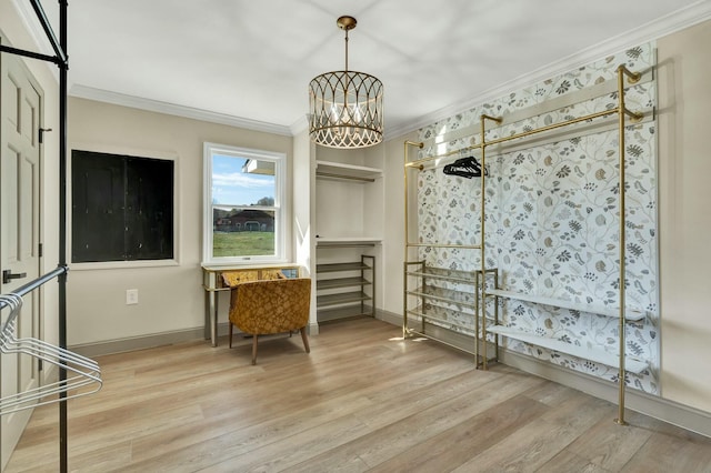 interior space featuring ornamental molding, light hardwood / wood-style floors, and a notable chandelier