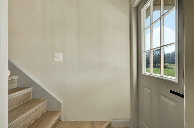 stairs featuring hardwood / wood-style floors