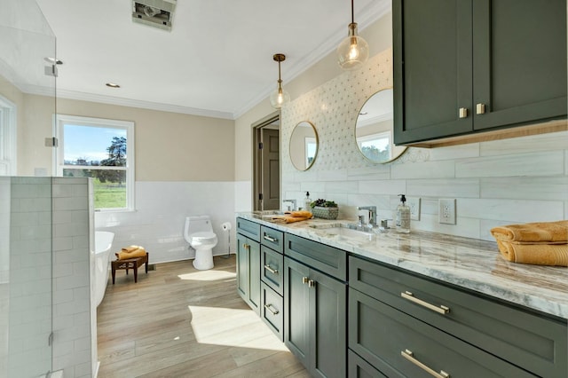 full bathroom featuring hardwood / wood-style floors, toilet, vanity, tile walls, and ornamental molding