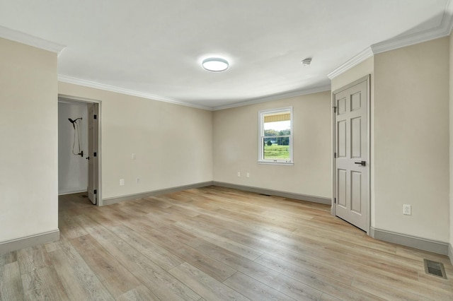 empty room featuring light hardwood / wood-style floors and ornamental molding