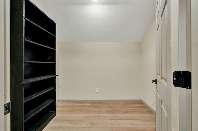 interior space with vaulted ceiling and light wood-type flooring