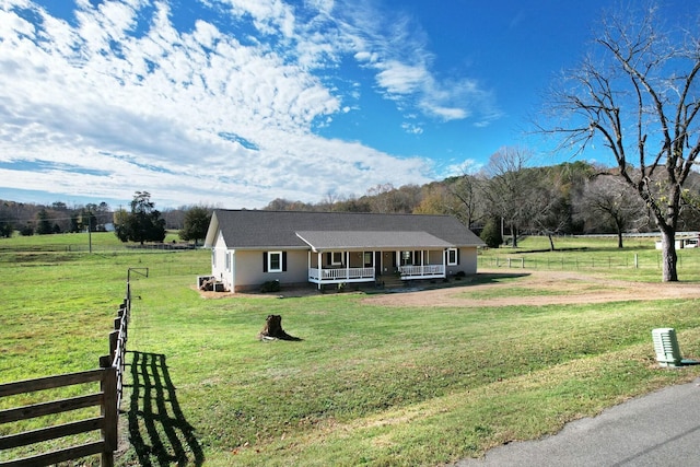 single story home with a porch, a rural view, and a front lawn