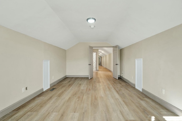 bonus room featuring light hardwood / wood-style flooring and vaulted ceiling