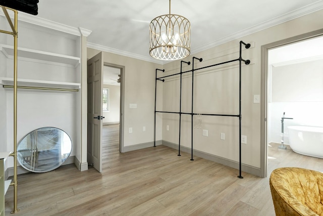 interior space featuring hardwood / wood-style flooring, ceiling fan with notable chandelier, ornamental molding, and a tub