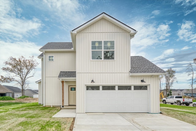 view of front of home featuring a garage and a front yard