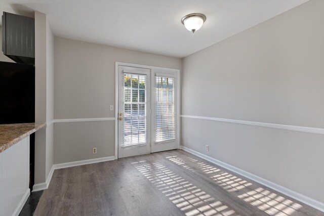 unfurnished dining area with wood-type flooring