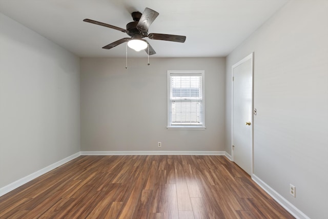 empty room with ceiling fan and dark wood-type flooring