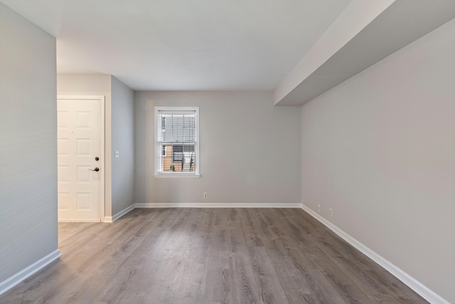 unfurnished room with wood-type flooring