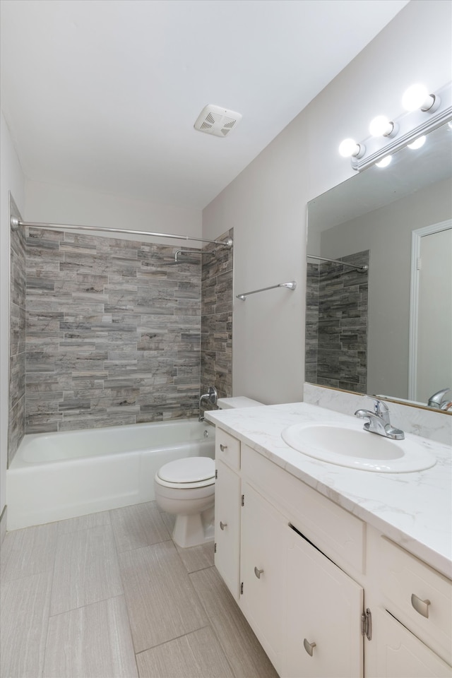 full bathroom featuring tile patterned floors, vanity, toilet, and tiled shower / bath