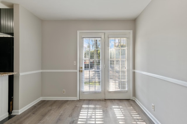 entryway with a wealth of natural light and light wood-type flooring