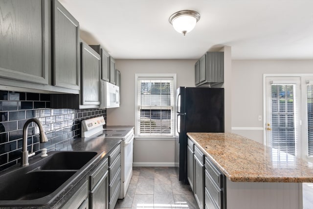 kitchen featuring plenty of natural light, electric range oven, decorative backsplash, and sink