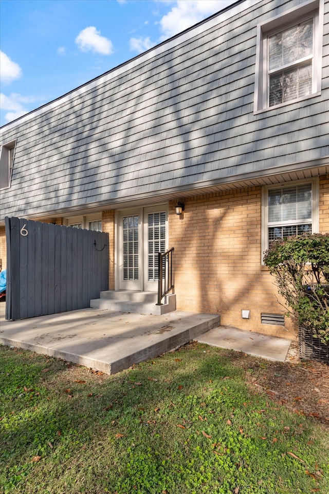 rear view of property featuring a yard