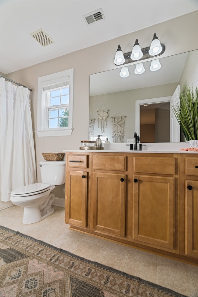 bathroom with tile patterned flooring, vanity, and toilet