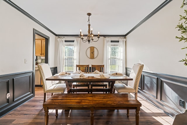 dining space featuring a notable chandelier, crown molding, and dark wood-type flooring