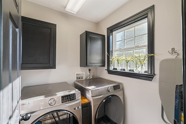 washroom with cabinets and independent washer and dryer