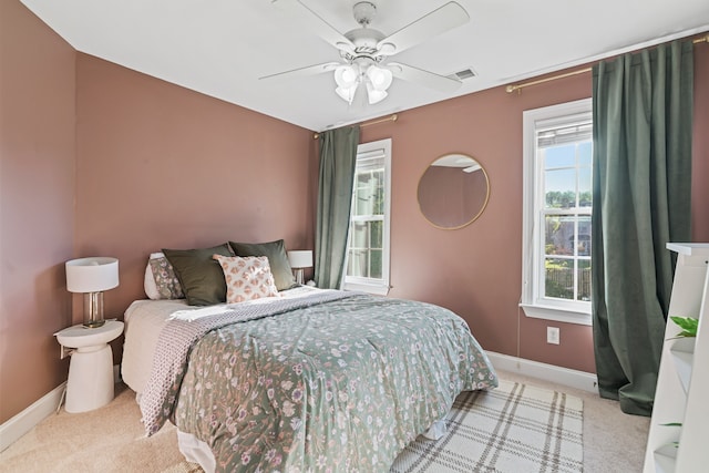 bedroom featuring ceiling fan and light carpet