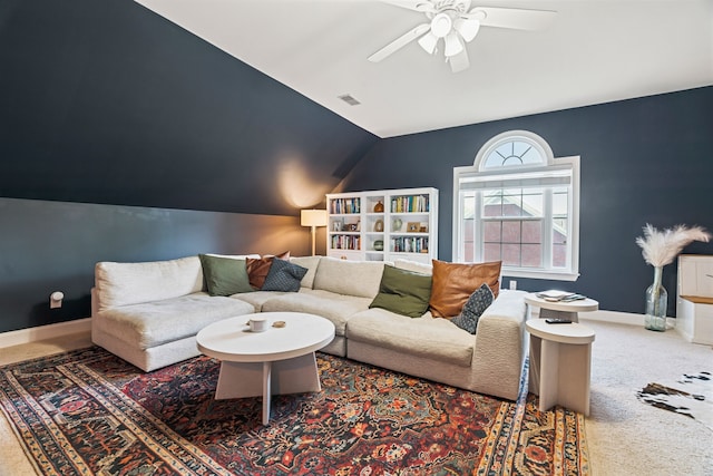 carpeted living room with ceiling fan and lofted ceiling