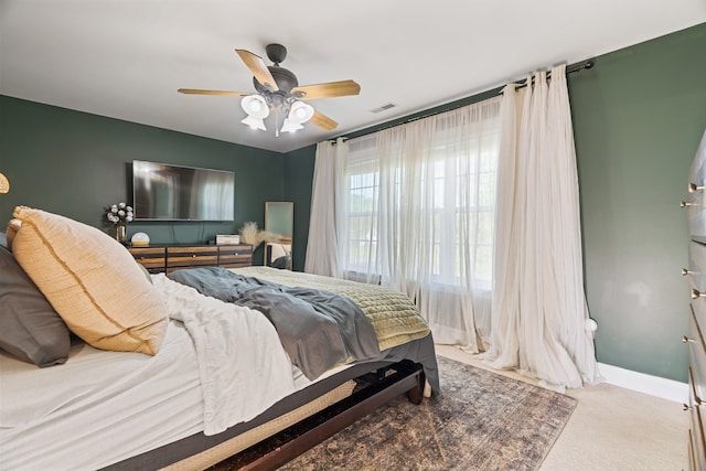 bedroom with ceiling fan and light carpet