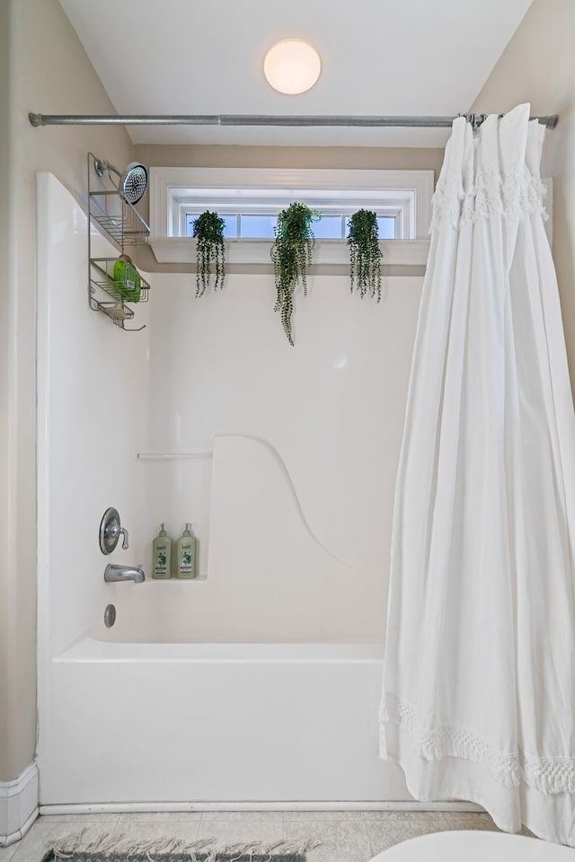 bathroom featuring a wealth of natural light and shower / bath combo