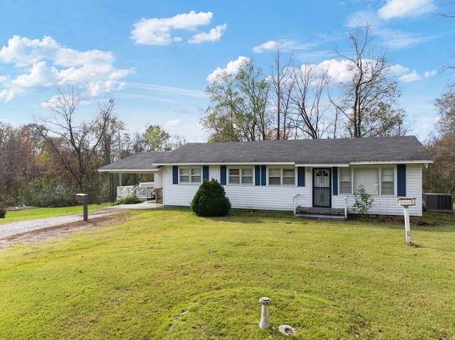 ranch-style house featuring a front lawn, cooling unit, and a carport