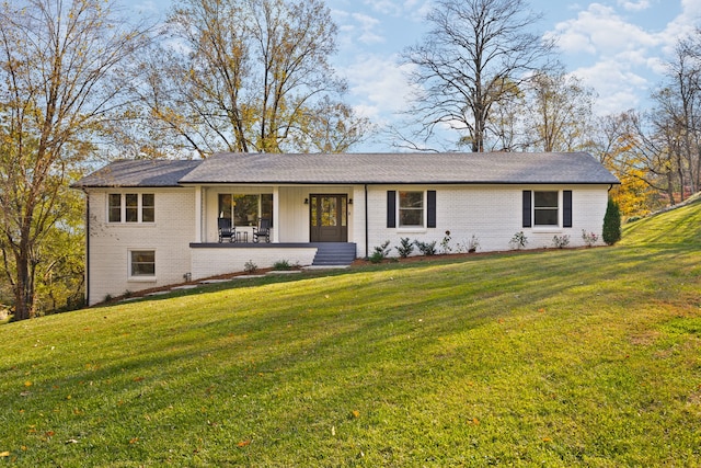 ranch-style home featuring a front yard and covered porch