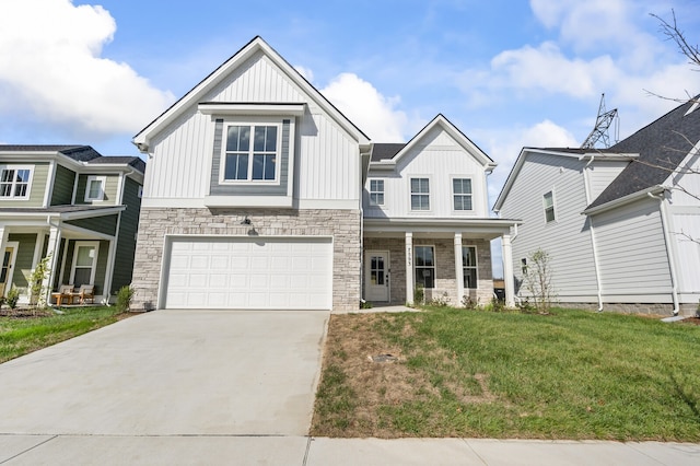 view of front facade featuring covered porch, a garage, and a front lawn