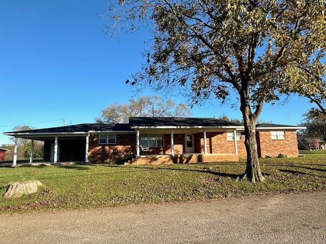 ranch-style home with a front lawn and a carport