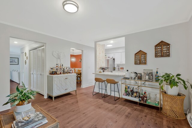 interior space with ornamental molding and hardwood / wood-style floors