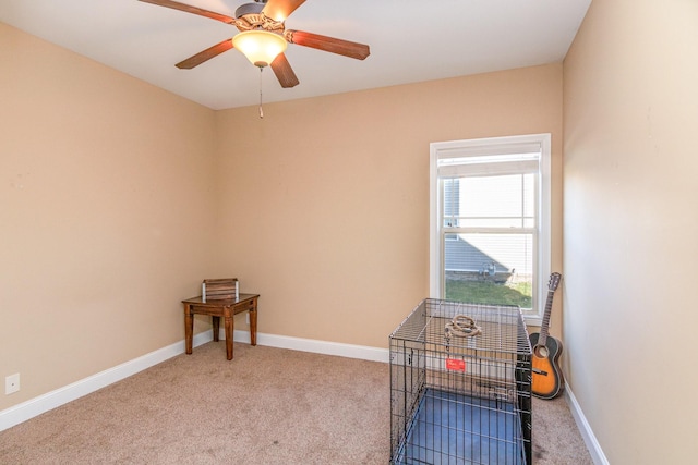 interior space featuring ceiling fan, baseboards, and carpet flooring