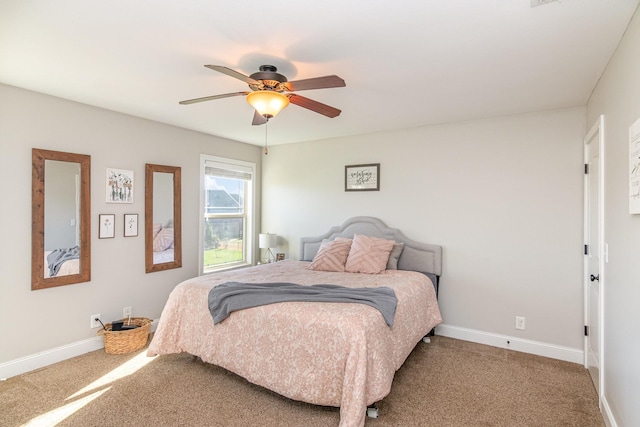 carpeted bedroom featuring a ceiling fan and baseboards