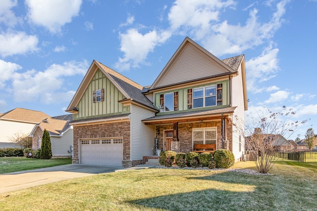 craftsman house with concrete driveway, stone siding, board and batten siding, and a front yard