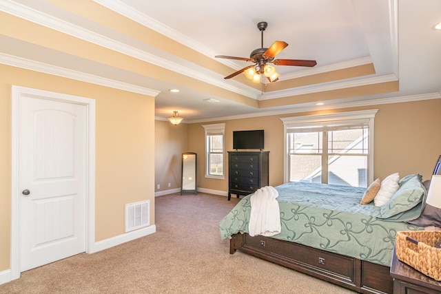 carpeted bedroom with baseboards, visible vents, a raised ceiling, ceiling fan, and ornamental molding